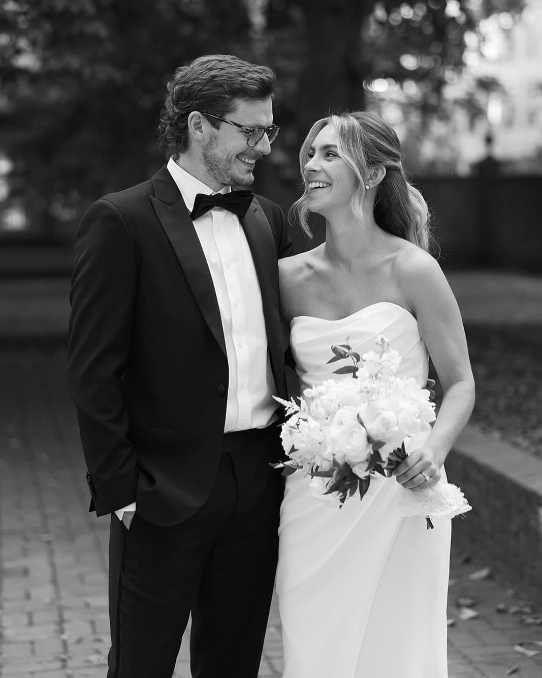 Black and white portrait of bride and groom with bouquet